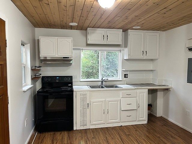 Kitchen with full-size range and an under-counter refrigerator.