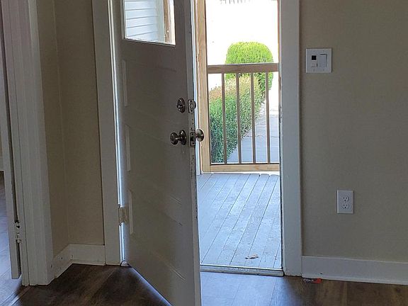 Front door opening to screened in front porch.