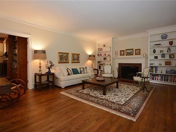 Living room has wonderful built-ins and gleaming hardwood floors.