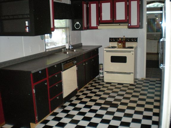 Modern kitchen with dining room nook off to the side. Newly replaced flooring