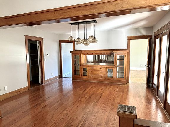 Dining room connects to the hallway (bathroom and bedroom access, left on photo), kitchen (second door from left), bedroom and mudroom/foyer on the right. The built in cabinet with mirrored back creates a rich speakeasy atmosphere of days gone by.