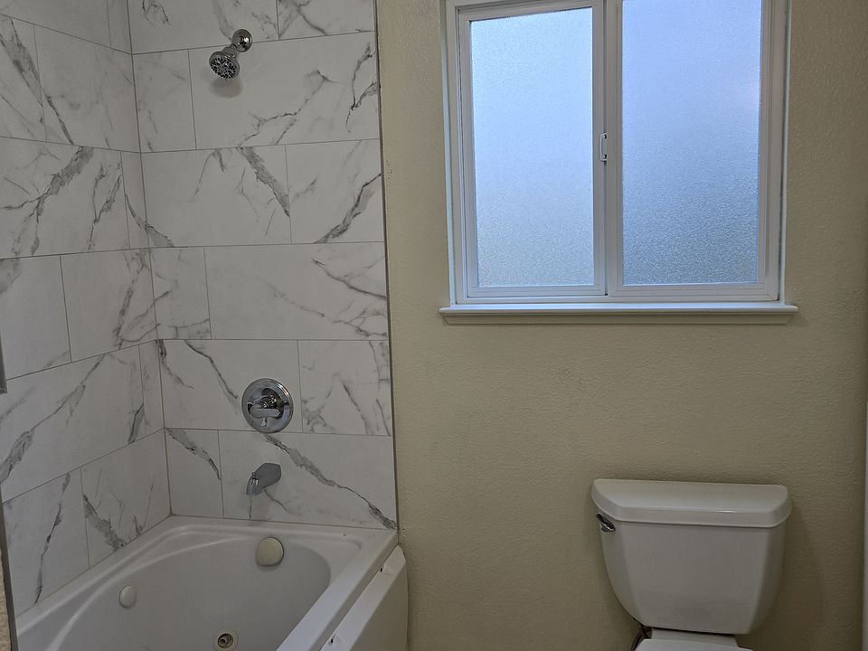 Jacuzzi tub and shower. Tile surround