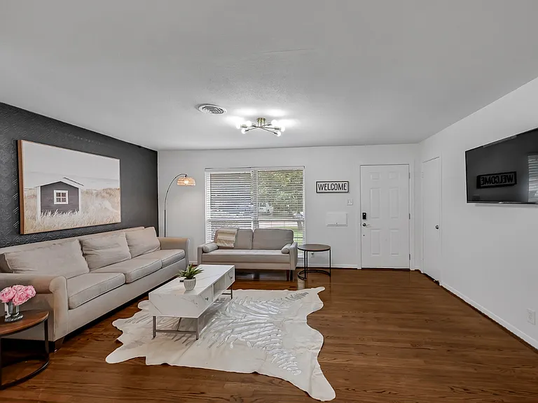 Another view of the living room with the front door