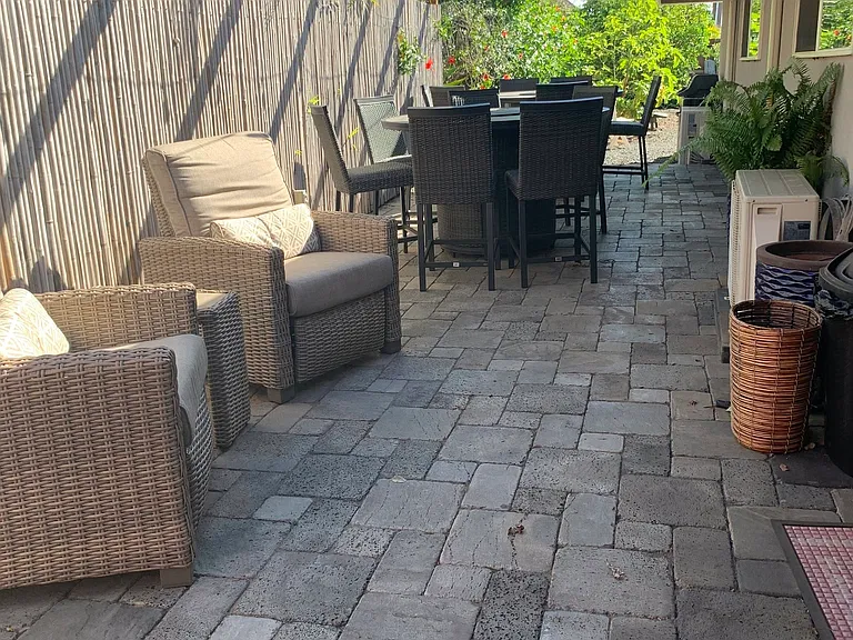 Outdoor entertainment area includes two fire pit dining tables with seating for 12 total plus two Barcaloungers for outdoor relaxation.