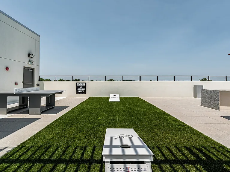 Green Space with Cornhole Boards on Rooftop Deck
