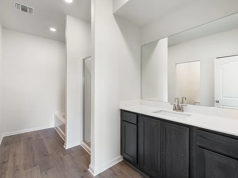 The master bathroom has a large vanity space.