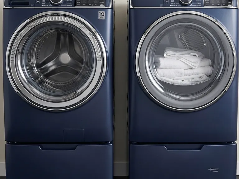 Front-loading washer and dryer, located in garage on upper level.