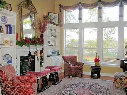 Directly in front of you is the living room with dramatic waterfront windows to capture the view