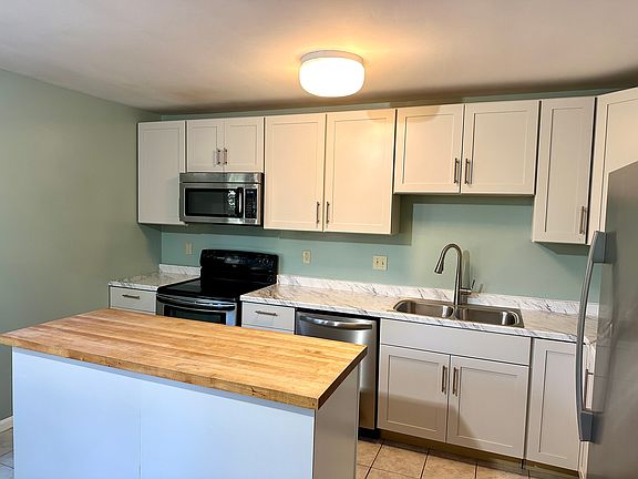 newly renovated kitchen with large butcher block top island