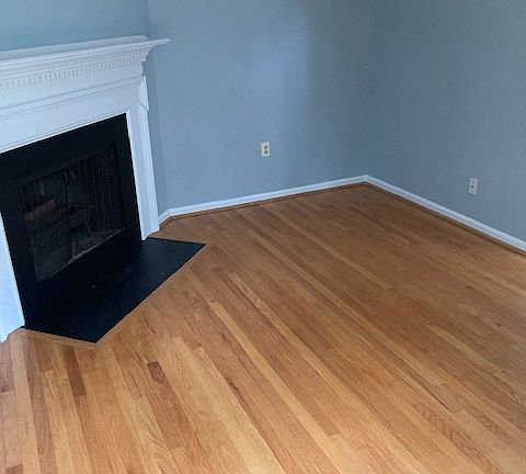 Den with wood burning fireplace