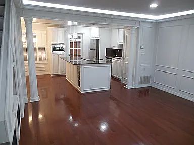 Island kitchen with granite countertops, full appliance package, and clean modern layout