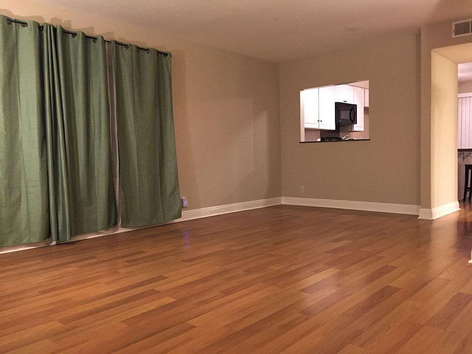 Living room with view into the kitchen.