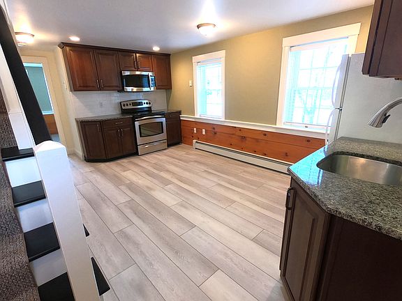 Renovated eat in kitchen with stainless steel oven, ceramic stovetop, and GE Profile Advantium microwave oven.