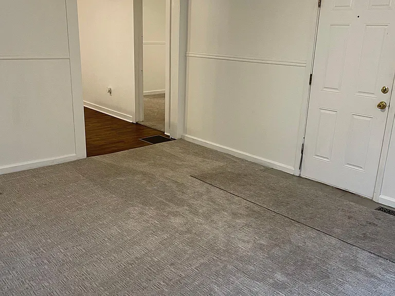 living room & front door looking into bedroom and kitchen