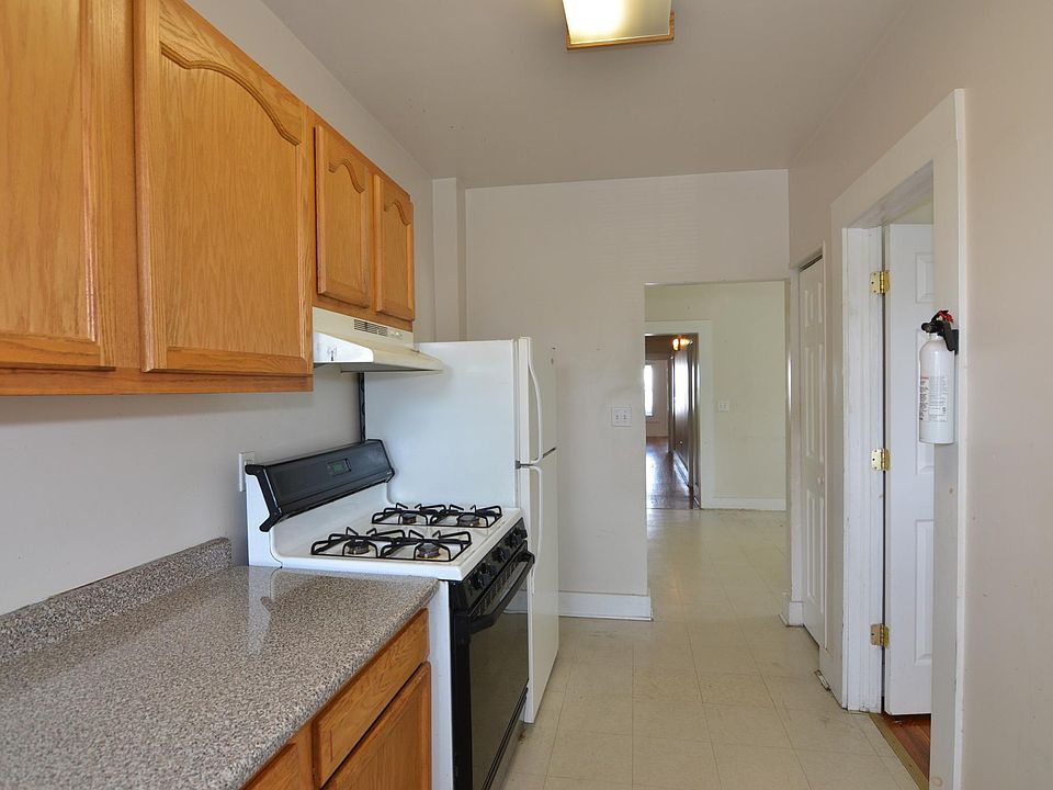 kitchen with gas stove and refrigerator, sturdy wooden cabinets