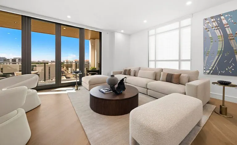 Sky Residence D living room with Restoration Hardware furnishings and stunning balcony views.