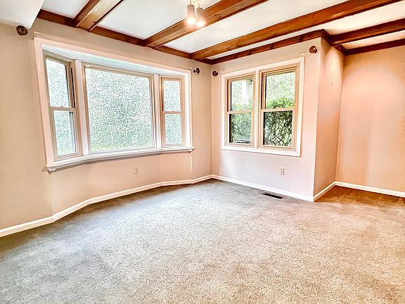 Bay window with view of woodlands.