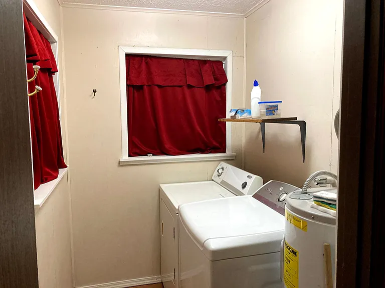 On the other side of the bathtub wall is the washer and dryer that can stay, even if you rent unfurnished.