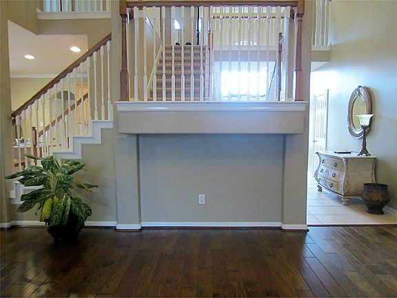 View of dual stair case from the Living room.