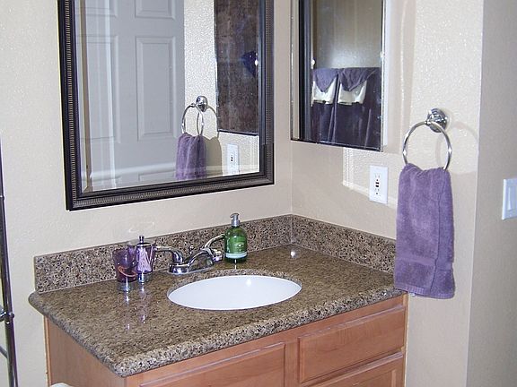 Master bath with upgraded granite and mirror.