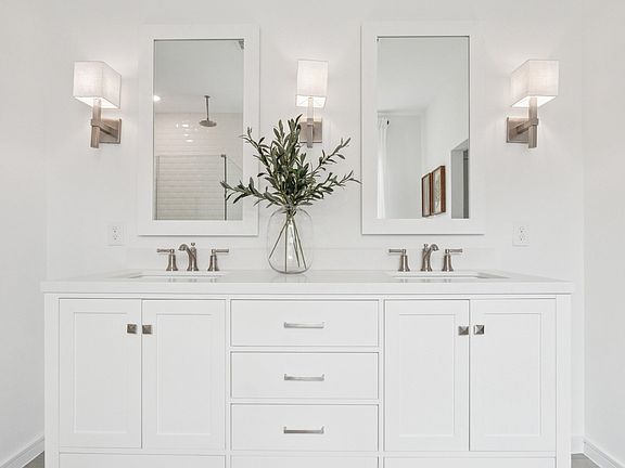 Primary bath features freestanding vanity with dual sinks