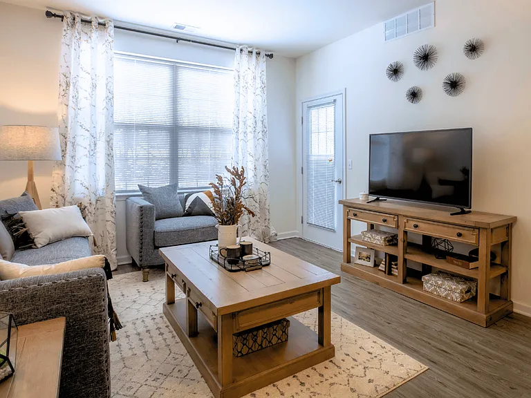 Modern, cozy living spaces with stylish decor, luxury flooring, and warm wood accents for a welcoming feel.