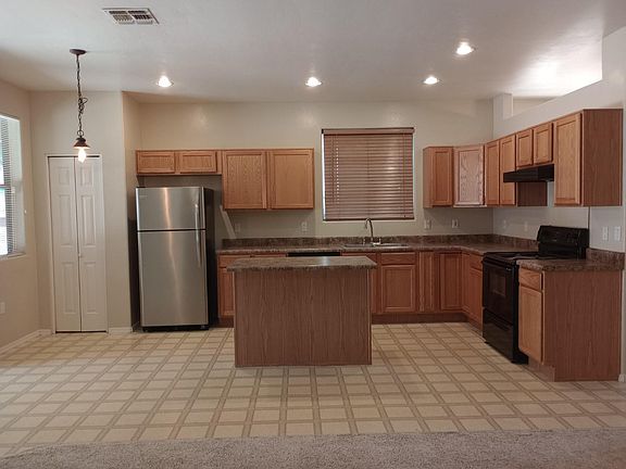 Open concept kitchen to media room. with island and dine in eating area.