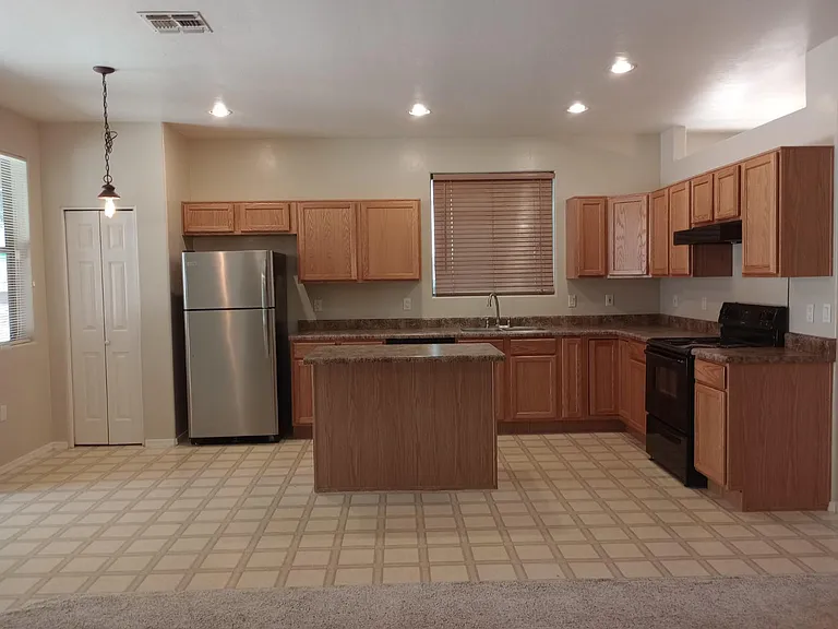 Open concept kitchen to media room. with island and dine in eating area.
