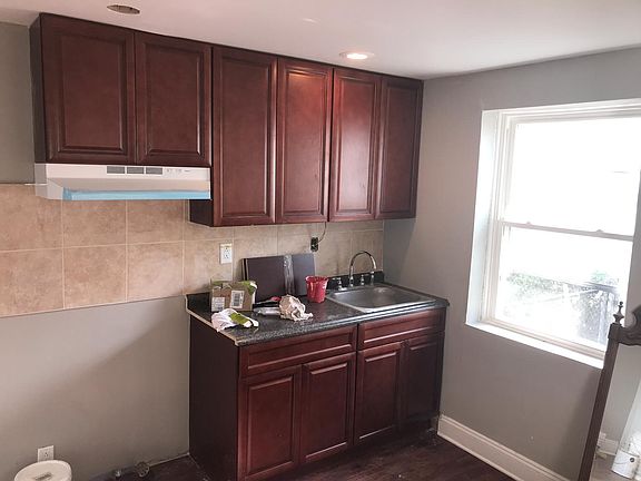 Newly done kitchen, with new hardwood cabinets and sink. Oven will be installed soon and comes with a new exhaust.