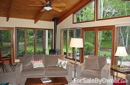 Four-Season Sun Room (NE Corner)
						:
						Ash walls painted in cottage yellow, vaulted knotty pine ceiling.