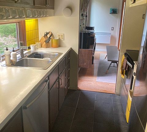 galley kitchen with range, dishwasher, refrigerator