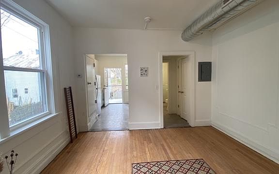 Living Room with Kitchen and Bath in background.