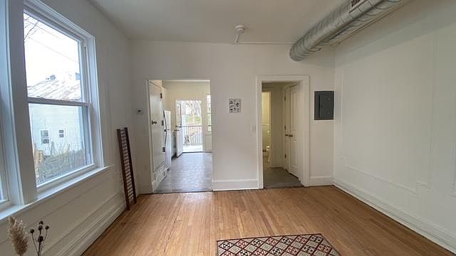 Living Room with Kitchen and Bath in background.