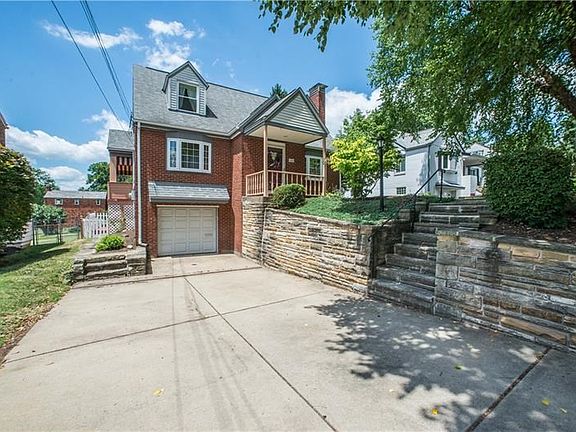 In addition to the one-car integral garage, guest parking is available in the extra-wide, level driveway. Stairs off the drive l
