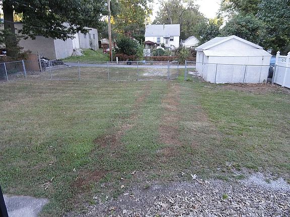Large back yard with parking area off of alley.