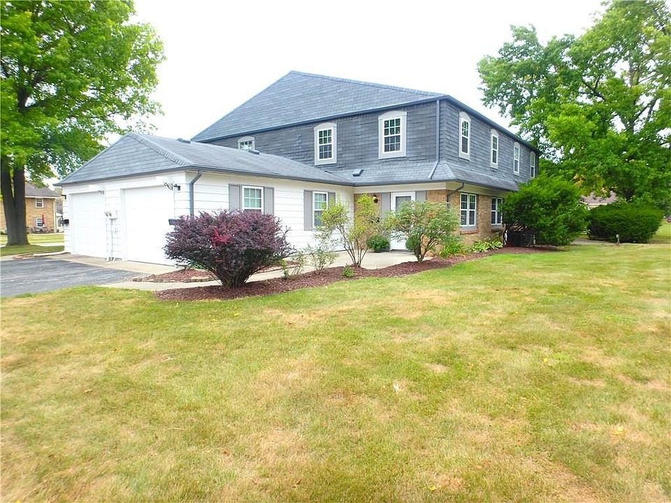 View of property and the attached private one car garage. The other garage is for the front unit. This great condo is minutes from I-65 and downtown. The HOA dues of $183.00 per month covers lawn care, snow removal, exterior building maintenance, pool, te
