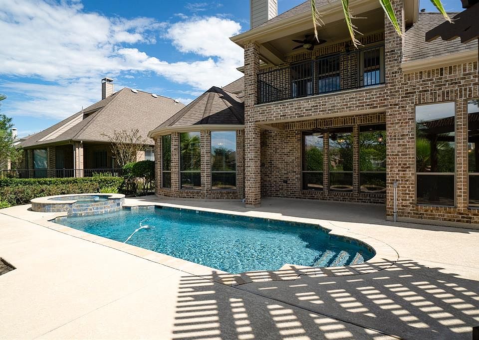 Amazing backyard oasis! Flagstone walk on both sides, outdoor shower, sprinkler system, gutters and mosquito sprayer.