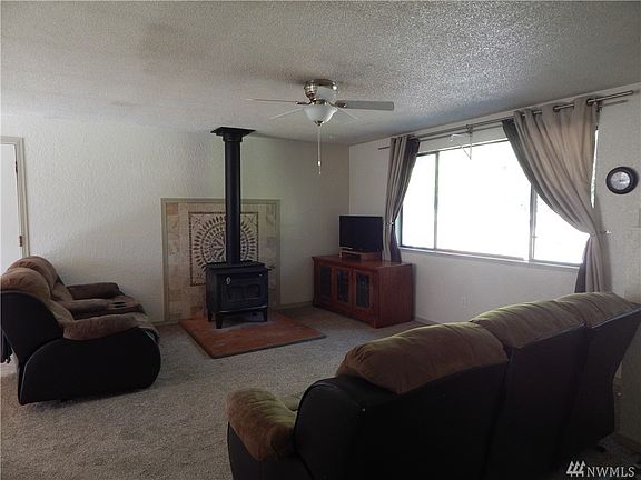 Living room is nice size and has a freestanding wood stove. 