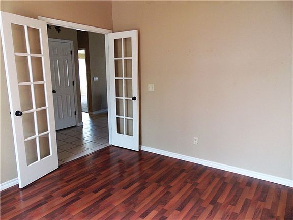 Study, Right Inside the Front Door with French Doors and Laminate Flooring.