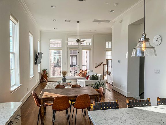 Open kitchen/living room concept with natural light flooding in from every angle.