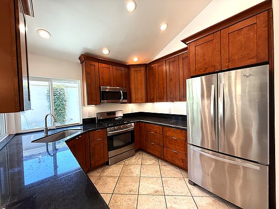 Kitchen with refrigerator, range, microwave and dishwasher. All applicances are included.