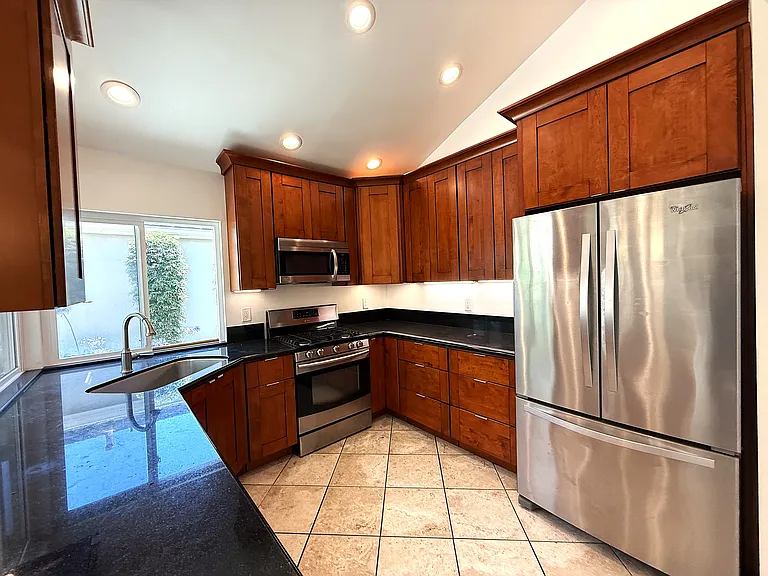 Kitchen with refrigerator, range, microwave and dishwasher. All applicances are included.