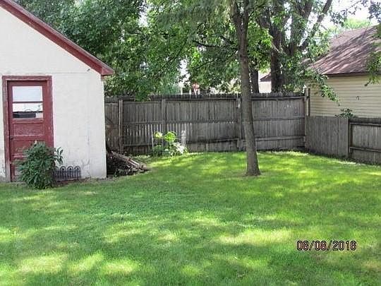 Back yard, fence, garden area and glimpse of garage.