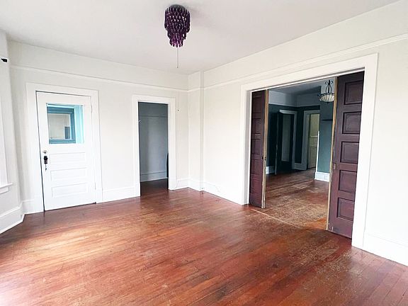 Living room. Door to balcony, closet and pocket doors leading to dining room