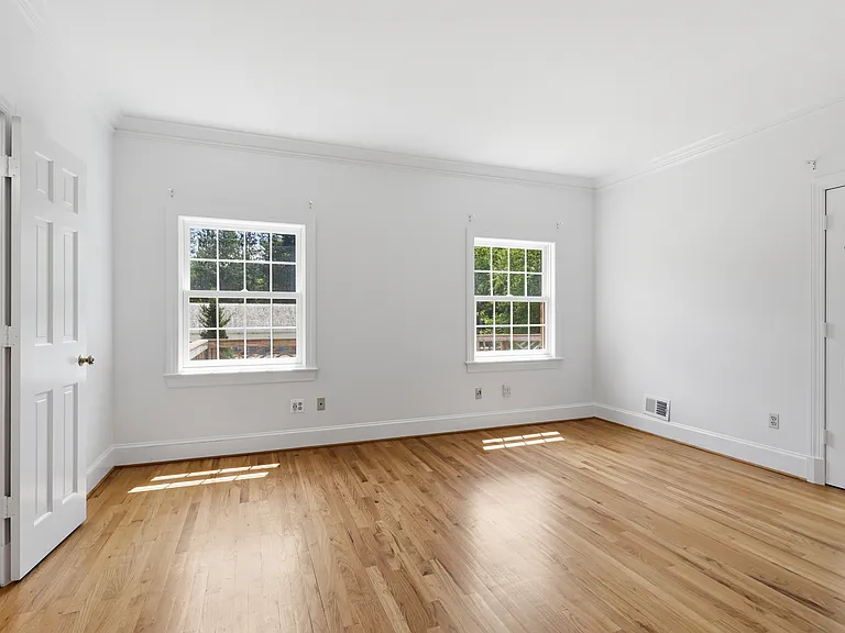 Main level bedroom, hardwood floors/wooded views.