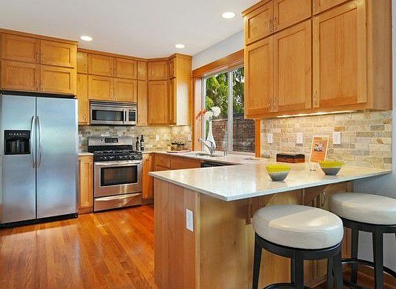 Chef's Delight - Beautiful limestone counters, gas range, and tons of storage in shaker sytle cabinets.
