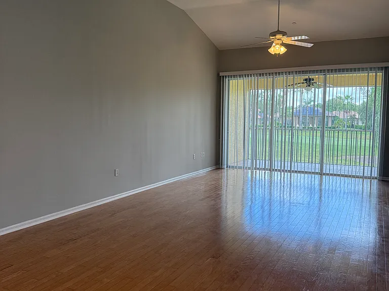 Living room with hard wood floors and high ceilings