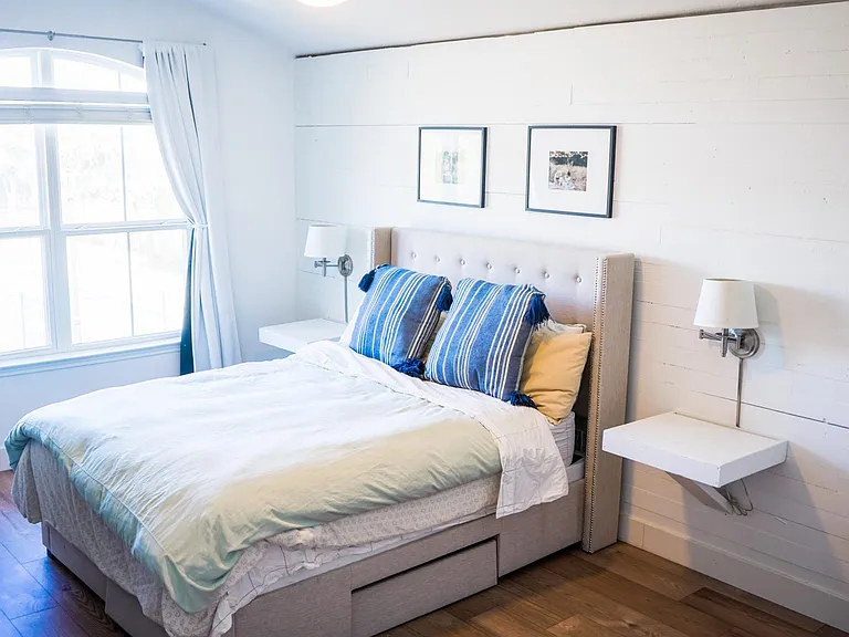Primary suite is spacious and bright, with a large picture window overlooking the pool