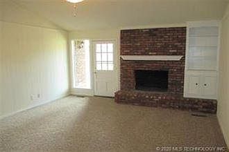 Vaulted Den w woodburning FP, backyard patio access