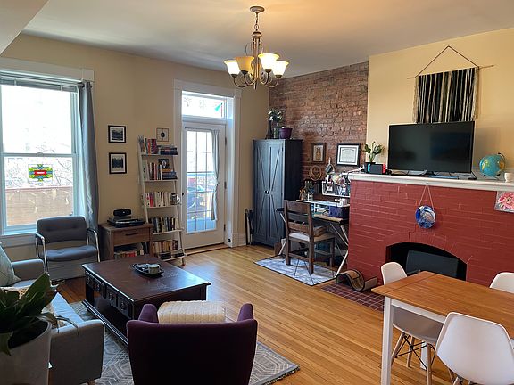 Living room, fireplace, and door to private deck